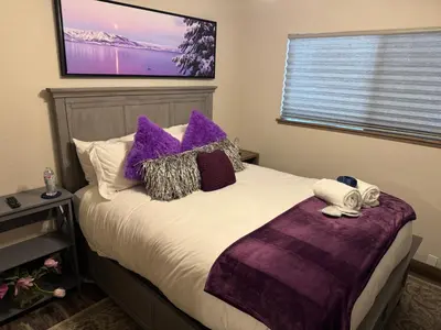 a bedroom with a bed with purple pillows at Lake Tahoe Incline Beach Ski Pool Pets Casino in Incline Village