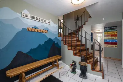 a hallway with a mural of mountains on the wall at Sequoia's Dream with Mountain View, Spa, Heated Floor, Bar, Cinema! in Oakhurst