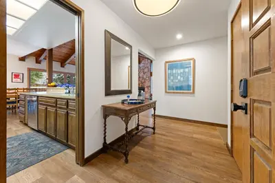 a hallway with a table and a mirror at Cabin for 8 HotTub Close to Ski Town Private Beach in Tahoe City