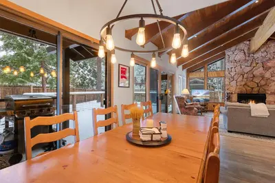 a dining room with a table and a fireplace at Cabin for 8 HotTub Close to Ski Town Private Beach in Tahoe City