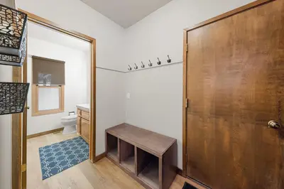 a bathroom with a toilet and a wooden door at Cabin for 8 HotTub Close to Ski Town Private Beach in Tahoe City