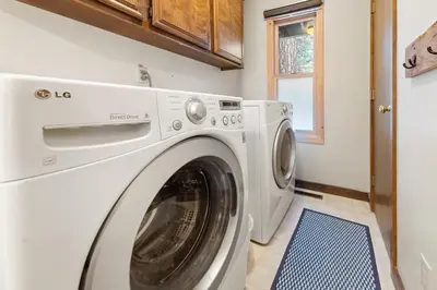 a white washer and dryer in a laundry room at Cabin for 8 HotTub Close to Ski Town Private Beach in Tahoe City