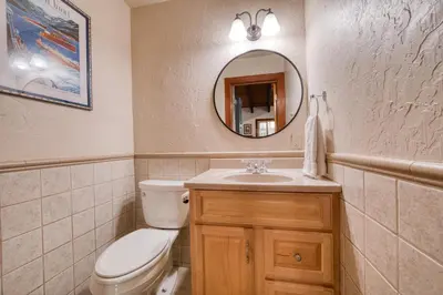 a bathroom with a toilet and a sink and a mirror at Wanderlust Retreat by Tahoe Getaways - 4BR Pet-Friendly w Fenced Yard, Walking Distance to Lake! in Tahoe City