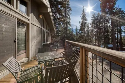 a balcony with a table and chairs on a house at Wanderlust Retreat by Tahoe Getaways - 4BR Pet-Friendly w Fenced Yard, Walking Distance to Lake! in Tahoe City