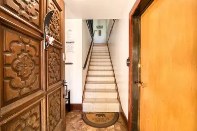 a hallway with a wooden door and a staircase at Wanderlust Retreat by Tahoe Getaways - 4BR Pet-Friendly w Fenced Yard, Walking Distance to Lake! in Tahoe City
