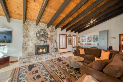 a living room with a couch and a fireplace at Wanderlust Retreat by Tahoe Getaways - 4BR Pet-Friendly w Fenced Yard, Walking Distance to Lake! in Tahoe City