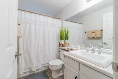 a white bathroom with a sink and a toilet at Modern 3-Bedroom Escape in Northwest Reno in Reno