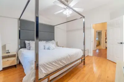 a bedroom with a canopy bed with a fan at Modern 3-Bedroom Escape in Northwest Reno in Reno