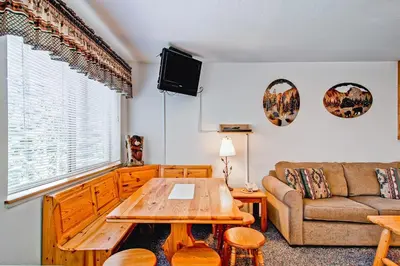 a living room with a couch and a table at Alpine View in Yosemite West