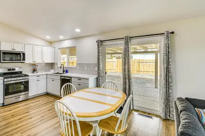 a kitchen and dining room with a table and a couch at 1 Mi to Pioneer Crossing Casino Fernley Retreat! in Fernley