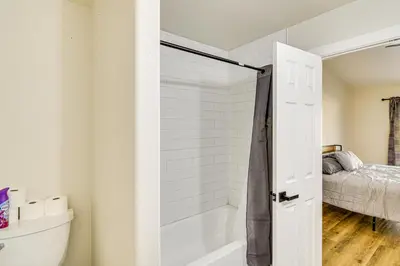 a bathroom with a tub and a shower door at 1 Mi to Pioneer Crossing Casino Fernley Retreat! in Fernley
