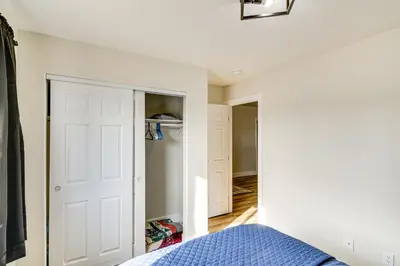a bedroom with a bed and a closet at 1 Mi to Pioneer Crossing Casino Fernley Retreat! in Fernley