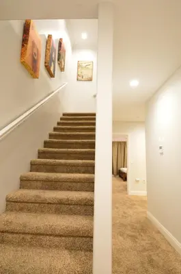 a staircase in a home with white walls and carpet at 3987 - Upscale Townhouse Walk to Heavenly, Casino and Beach in South Lake Tahoe