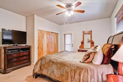 a bedroom with a bed and a flat screen tv at Eagles Nest in Yosemite West