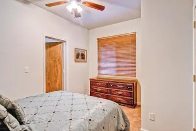 a bedroom with a bed and a dresser and a window at Eagles Nest in Yosemite West