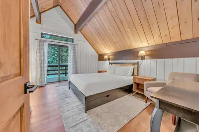 a bedroom with a bed and a desk in a room at Tahoe City Vacation Rental with Fireplace and Deck in Tahoe City