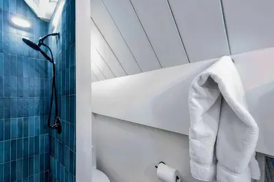 a bathroom with a shower and a toilet and a towel at Tahoe City Vacation Rental with Fireplace and Deck in Tahoe City