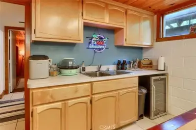 a kitchen with wooden cabinets and a sink at Lake View Cabin Private Dock Free Night Special in Bass Lake