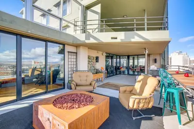 a house with a balcony with chairs and a table at Luxe Dtwn Reno Penthouse about 3 Mi to Casinos! in Reno