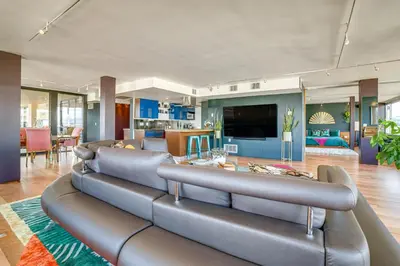a living room with a couch and a table at Luxe Dtwn Reno Penthouse about 3 Mi to Casinos! in Reno