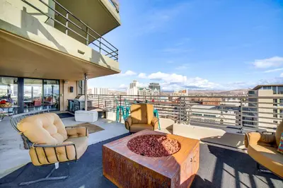 a balcony with chairs and a table on a building at Luxe Dtwn Reno Penthouse about 3 Mi to Casinos! in Reno