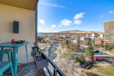 a balcony with a table and a view of a city at Luxe Dtwn Reno Penthouse about 3 Mi to Casinos! in Reno