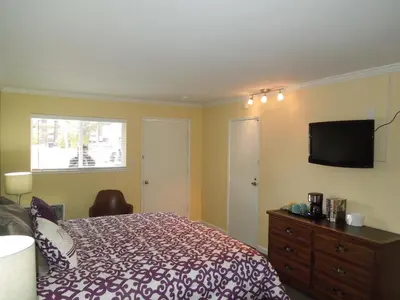 a bedroom with a bed and a flat screen tv at Tea Garden Lodge in South Lake Tahoe