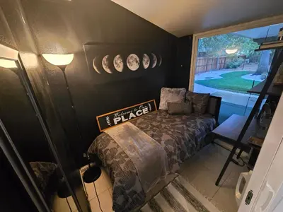 a bedroom with a bed and plates on the wall at Charming peaceful stay in Sacramento