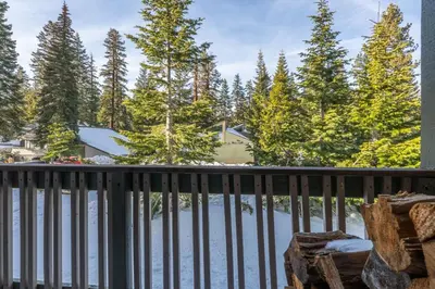a balcony with a view of a lake and trees at Crestview #3 bldg C 1 Bedroom plus Den / 2 Bathroom, close to town shuttle and short walk to village in Mammoth Lakes