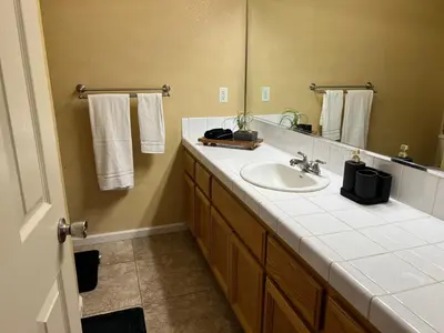 a bathroom with a sink and a mirror at Cozy House in Fallon- 3BedRoom, 2BathRooms in Fallon
