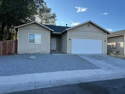 a house with a garage and a driveway at Cozy House in Fallon- 3BedRoom, 2BathRooms in Fallon