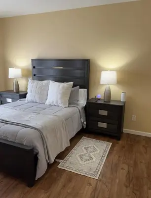 a bedroom with a large bed with two night stands and two lamps at Cozy House in Fallon- 3BedRoom, 2BathRooms in Fallon