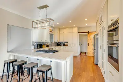 a kitchen with a counter with stools around it at Mtn-View Haven with Hot Tub! 28 Mi to Mt Rose Ski in Sparks