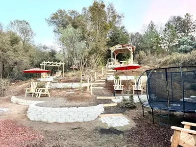 a playground with tables and chairs and umbrellas at The Ultimate Mountain Retreat close Yosemite and Bass Lake in Oakhurst