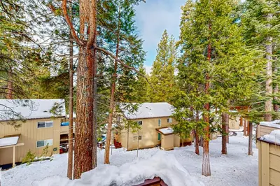 a building in the woods with snow on the ground at The Pines Chalet in Incline Village