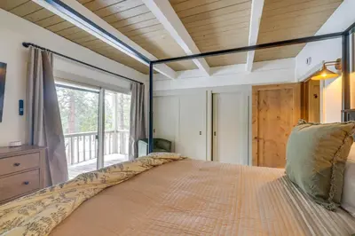 a bedroom with a large bed with a large window at 8 Mi to Northstar Slopes Tahoe Gem with Fireplace in Kings Beach