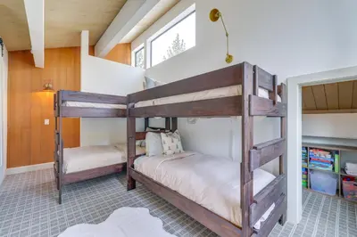 two bunk beds in a room with a window at 8 Mi to Northstar Slopes Tahoe Gem with Fireplace in Kings Beach