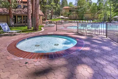 a hot tub in a patio with chairs and a pool at 8 Mi to Northstar Slopes Tahoe Gem with Fireplace in Kings Beach