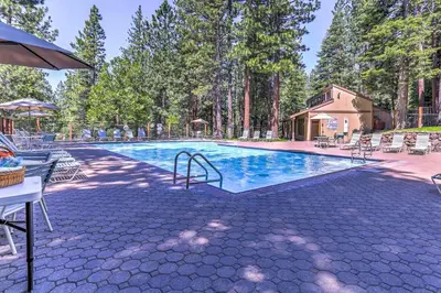 a swimming pool with chairs and a house at 8 Mi to Northstar Slopes Tahoe Gem with Fireplace in Kings Beach