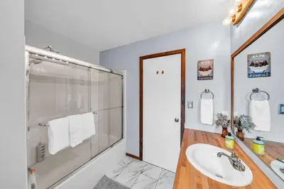 a bathroom with a glass shower and a sink at Cozy Kings Beach Vacation Rental with Deck in Kings Beach
