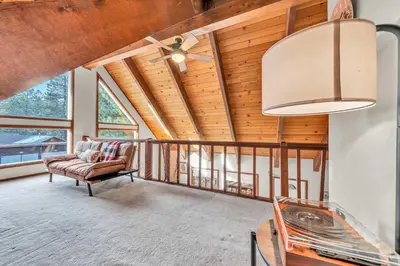 a living room with a chair and a ceiling fan at Cozy Kings Beach Vacation Rental with Deck in Kings Beach