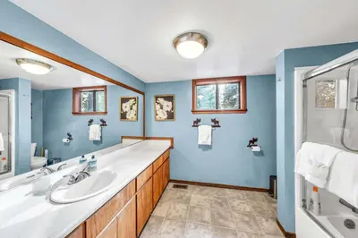 a bathroom with blue walls and a sink and a tub at Cozy Kings Beach Vacation Rental with Deck in Kings Beach