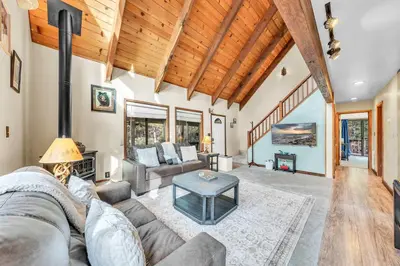 a living room with a couch and a table at Cozy Kings Beach Vacation Rental with Deck in Kings Beach