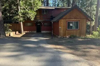 a house in the woods with a driveway at Spacious Tahoe Hot Tub and Beach in Kings Beach