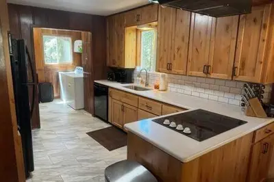 a kitchen with wooden cabinets and a stove top oven at Spacious Tahoe Hot Tub and Beach in Kings Beach