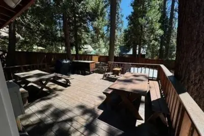 a patio with picnic tables and a fence at Spacious Tahoe Hot Tub and Beach in Kings Beach