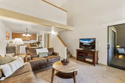 a living room with a couch and a table at Lakeland Village 2 Bed Condo Pool View in South Lake Tahoe