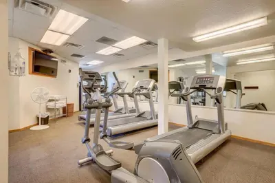 a gym with treadmills and ellipticals in a room at Lakeland Village 2 Bed Condo Pool View in South Lake Tahoe