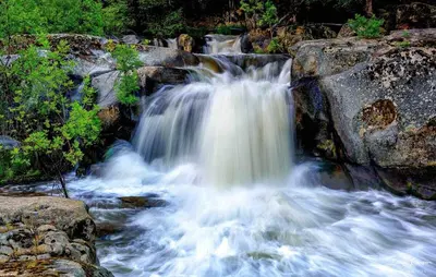 a waterfall on the side of a river at Waterfall Lodge near Yosemite Endless Pool, Hot Tub, Playground in Oakhurst