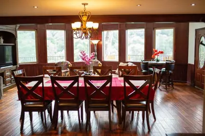 a dining room with a red table and chairs at Waterfall Lodge near Yosemite Endless Pool, Hot Tub, Playground in Oakhurst